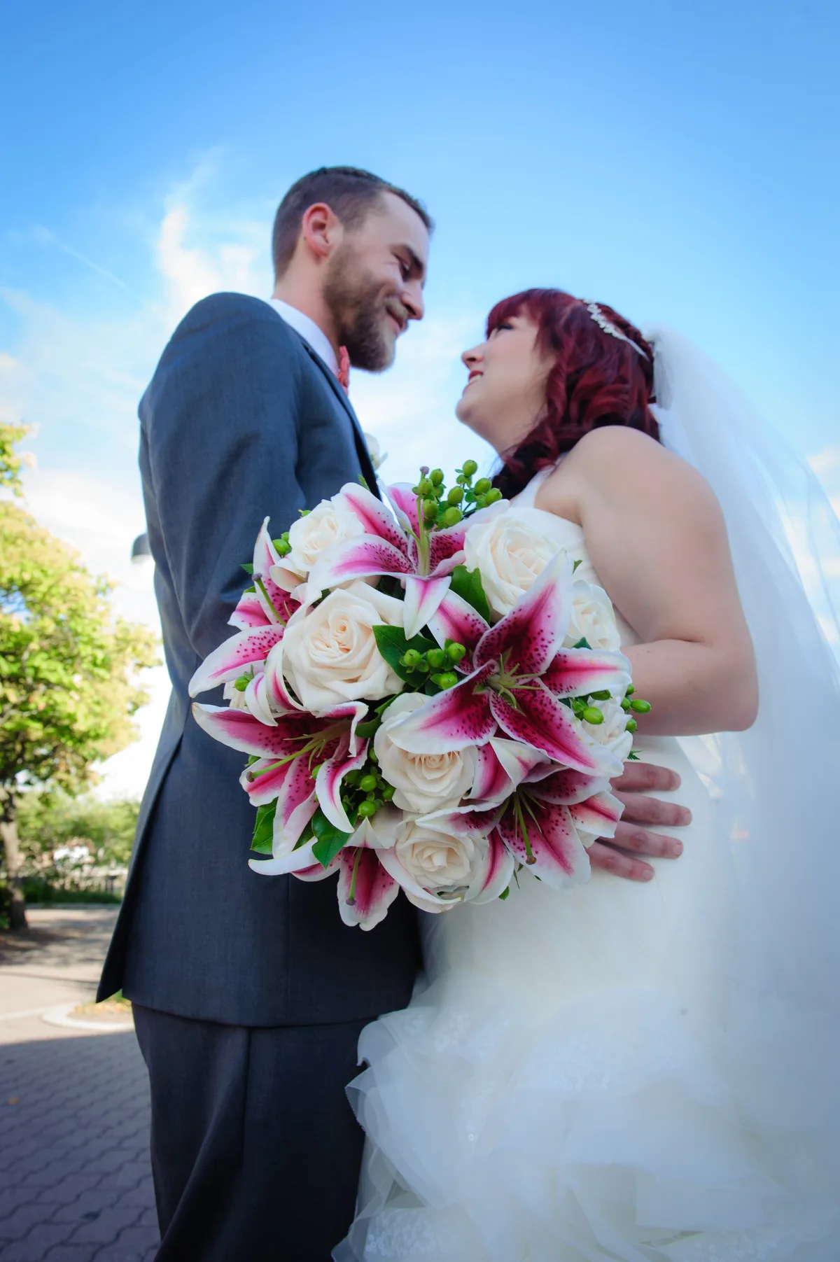 Couple reviewing their wedding photo gallery together on a laptop