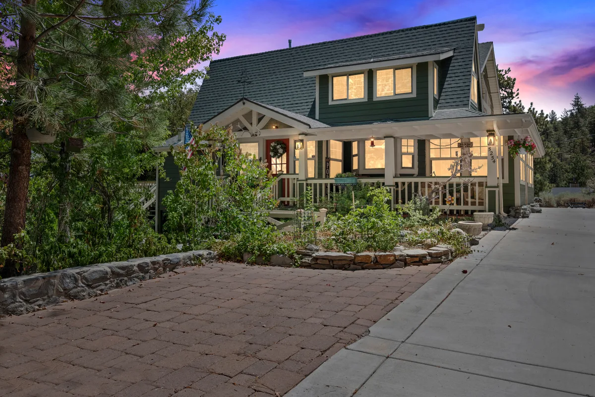 Twilight exterior photo of a home with warm interior lighting