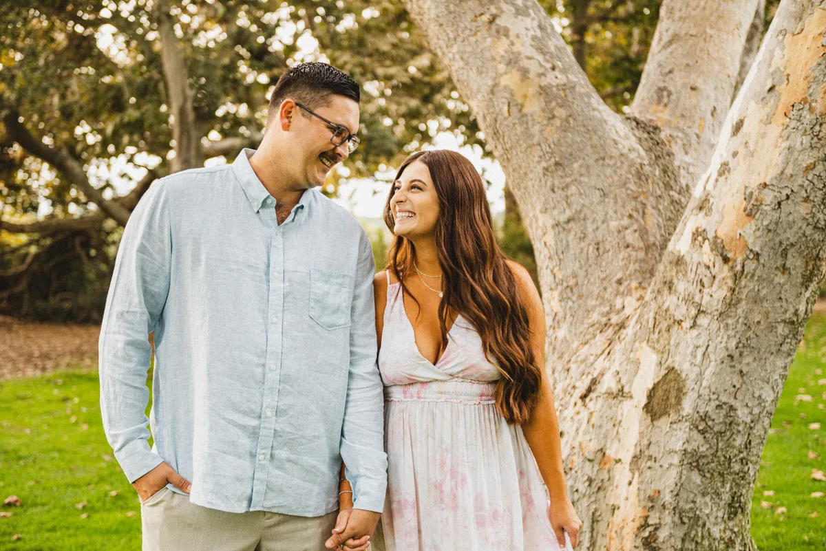 Couple walking hand-in-hand through a downtown engagement session location